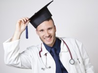 young doctor smiling with mortarboard