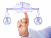 Index finger of a business manager touching a cloud symbol to access a virtual balance. The weighing scale is keeping a male and a female worker in temporary equilibrium. Cutout on white background.